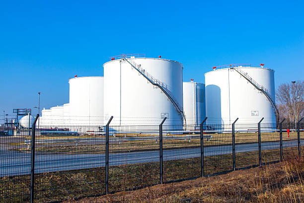 white tank in tank farm with blue sky